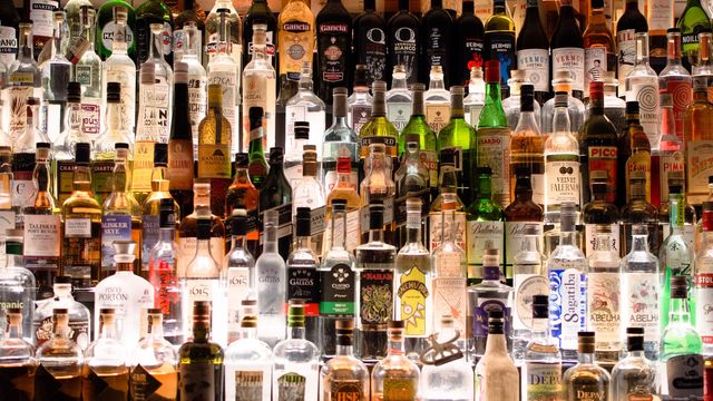 A bar filled with bottles of alcohol. 